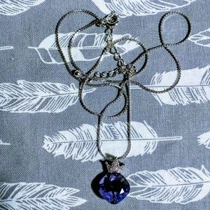 Rounded square cut purple gem with a crystal crown